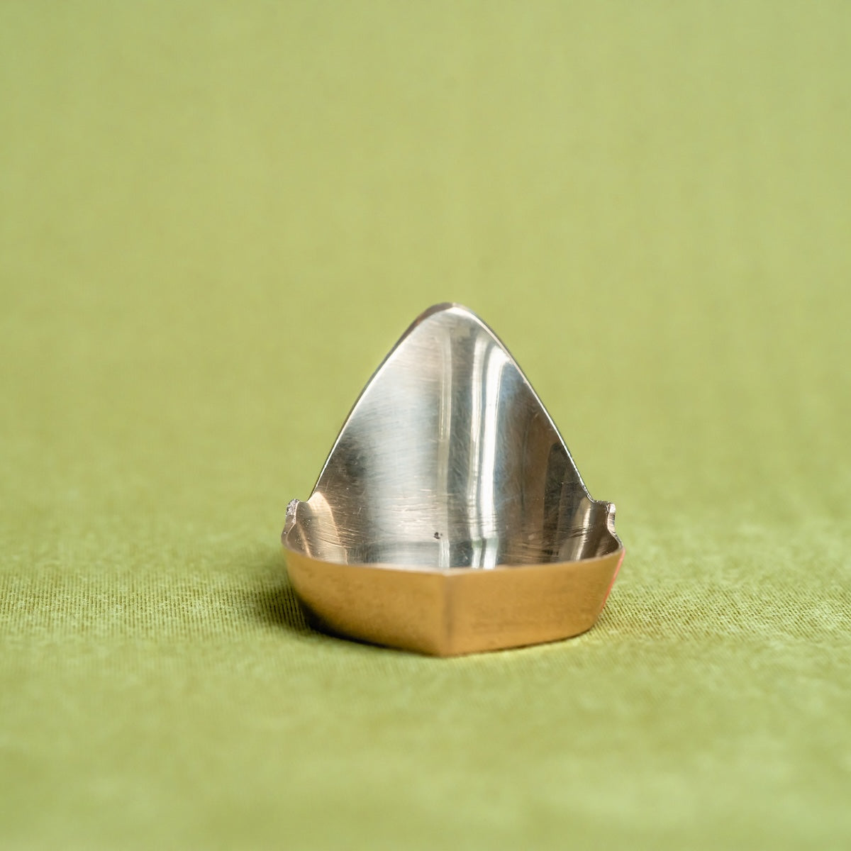 Brass Mada Vilakku Deepam on a green fabric background-Zishta Traditional Decor-Navratri Gifting