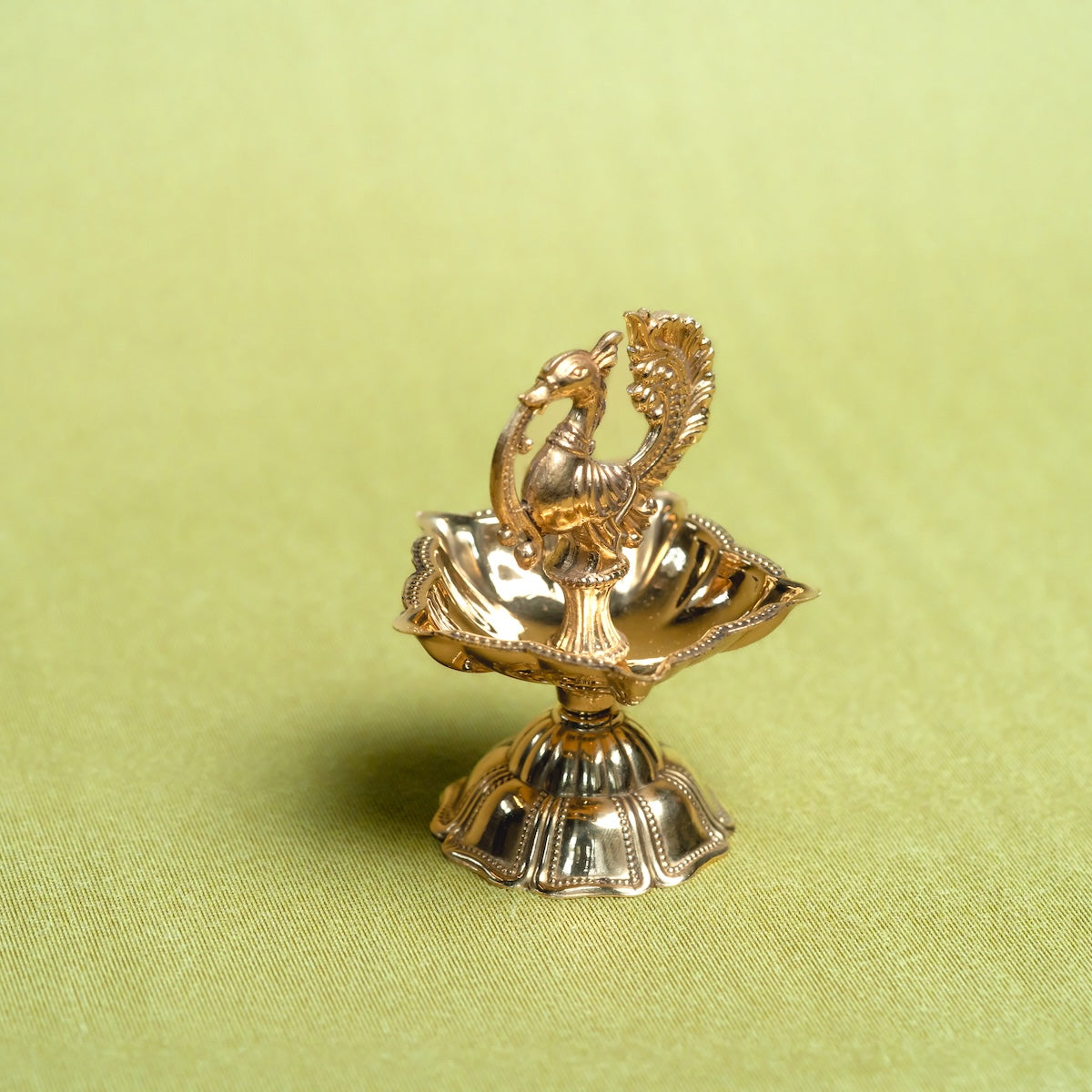 Brass Annam Diya Lamp-decorative item with intricate designs on a green background-Zishta Traditional Decor-Diwali and Navratri Gifts