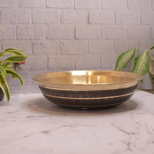Brass Basin Paraat on a marble surface with a light gray brick wall background-Zishta Traditional Kitchen Accessories