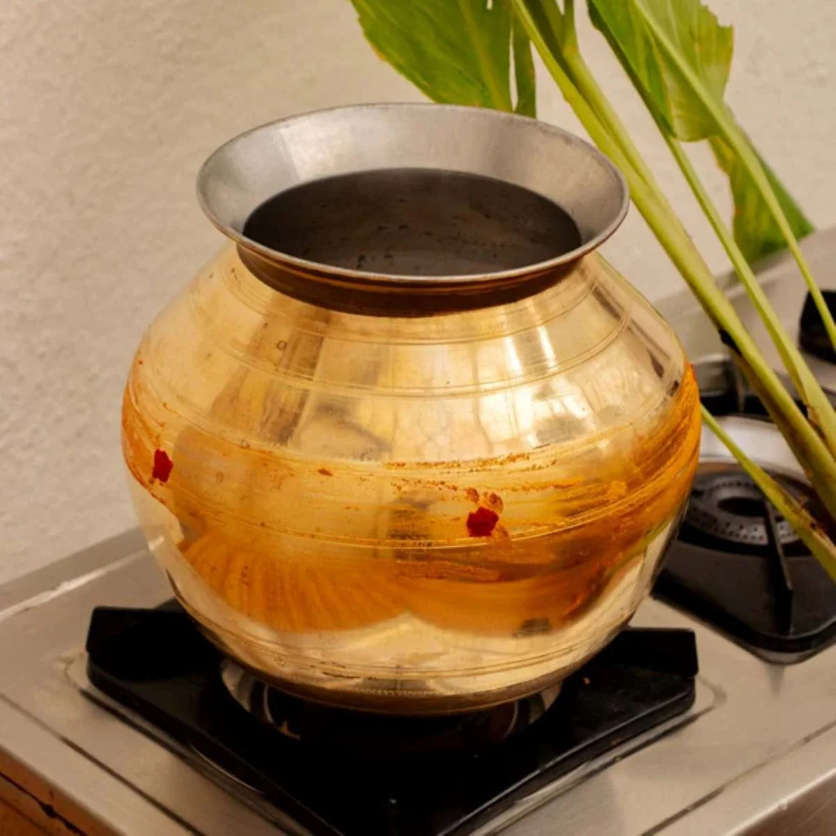 Brass Cooking Pot-Pongal Pot placed on a Stove-Zishta Traditional Cookware