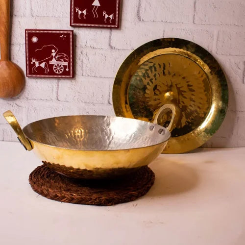 Brass Kadai and Lid on a white surface with a white brick wall background-Zishta Traditional Cookware