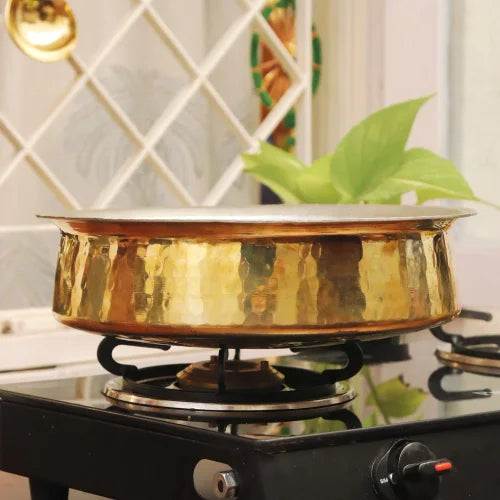 Brass Lagan For Cooking on a stove with a decorative background-Zishta Traditional Cookware