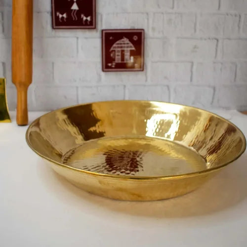 Brass Paraat on a white surface with a white brick wall background-Zishta Traditional Kitchen Accessories