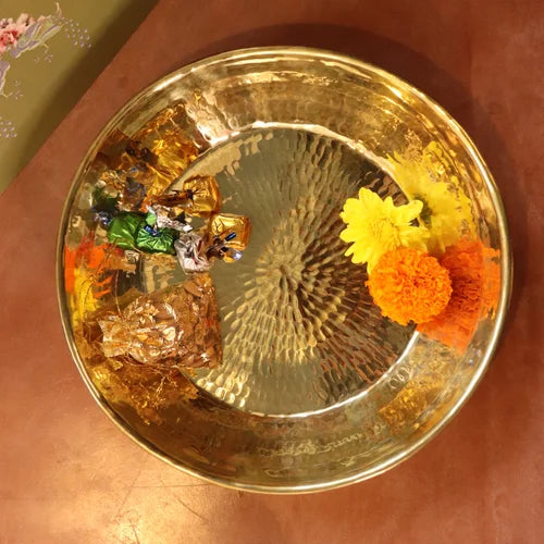 Brass Paraat with flowers and decorative items on a reflective surface-Zishta Traditional Kitchen Accessories