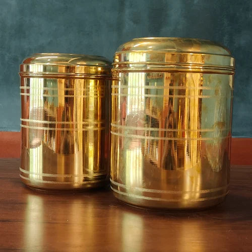 Two brass storage containers with decorative patterns on a wooden surface-Zishta Storage Containers