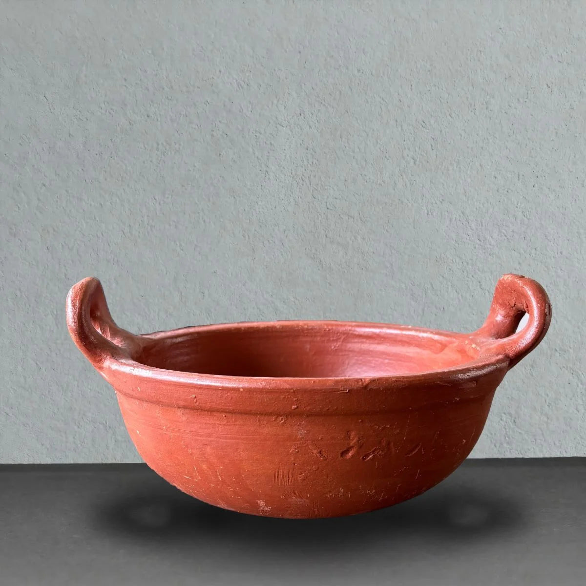 Clay Kadai with Curved Handle Front View. Zishta Traditional Earthenware Cookware.