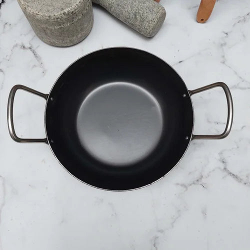 Pure Iron Flat Bottom Kadai on a marble surface with kitchen utensils in the background-Zishta Traditional Cookware