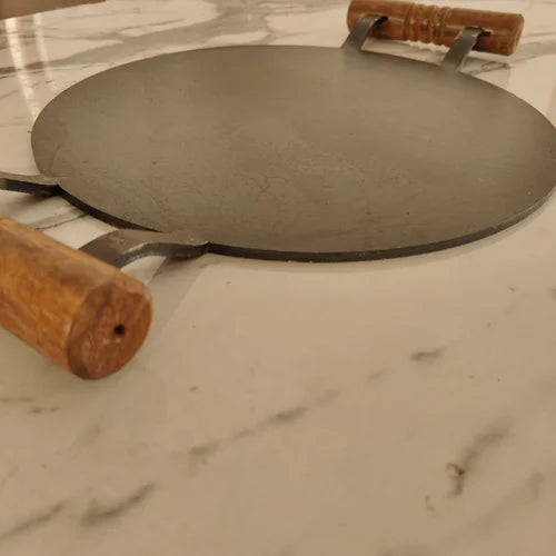 Pure Iron Round Tawa with Wooden handle on a marble surface-Zishta Traditional Cookware