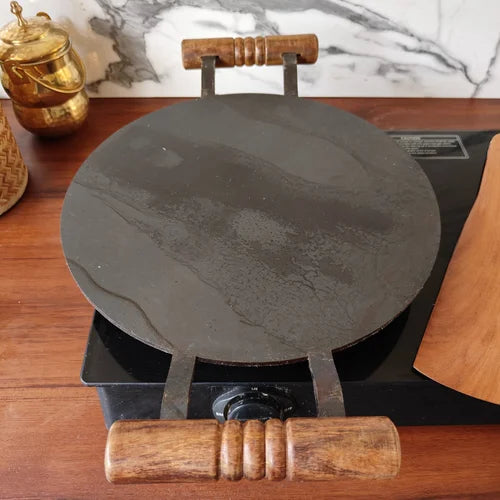 Pure Iron Round Tawa with Wooden handle on a wooden surface-Zishta Traditional Cookware