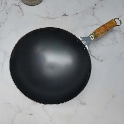 Pure Iron wok with a wooden handle on a marble surface-Zishta Traditional Cookware