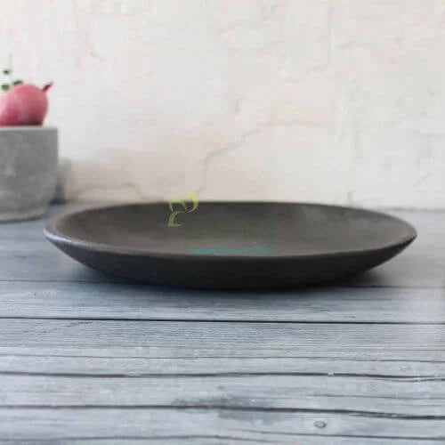 Manipur Black Pottery Serving Dining on a wooden surface with a blurred background-Zishta Traditional Serveware