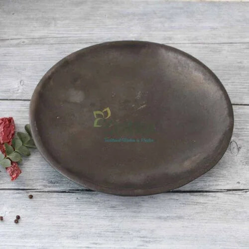 Manipur Black Pottery Serving Dining plate on a light wooden surface with a logo and text-Zishta Traditional Serveware