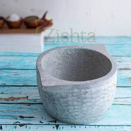 Gray soapstone kalchatti on a blue wooden surface-zishta Traditional Cookware
