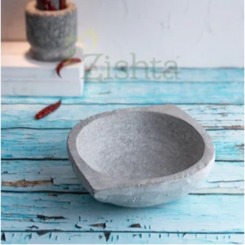 Soapstone Kadai on a blue wooden surface with kitchen utensils in the background-Zishta Traditional Cookware
