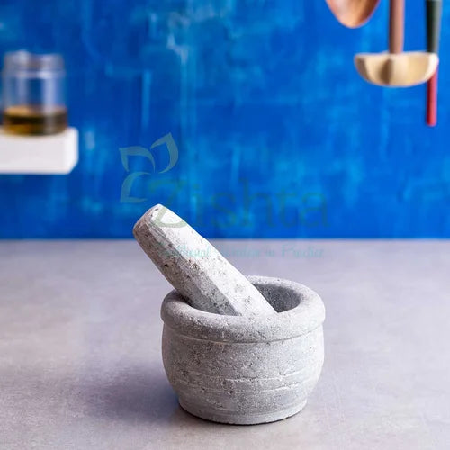 Soapstone Maakal Mortar and pestle on a gray surface with a blue background-Zishta Traditional Kitchen Accessories