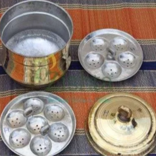 Brass Idli Vessel Idli Maker Idli Cooker Set with lid on a striped fabric background-Zishta Traditional Cookware
