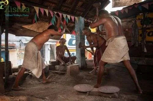 Artisans working on making iron dosa tawa on a rustic outdoor setting-Zishta Traditional Cookware