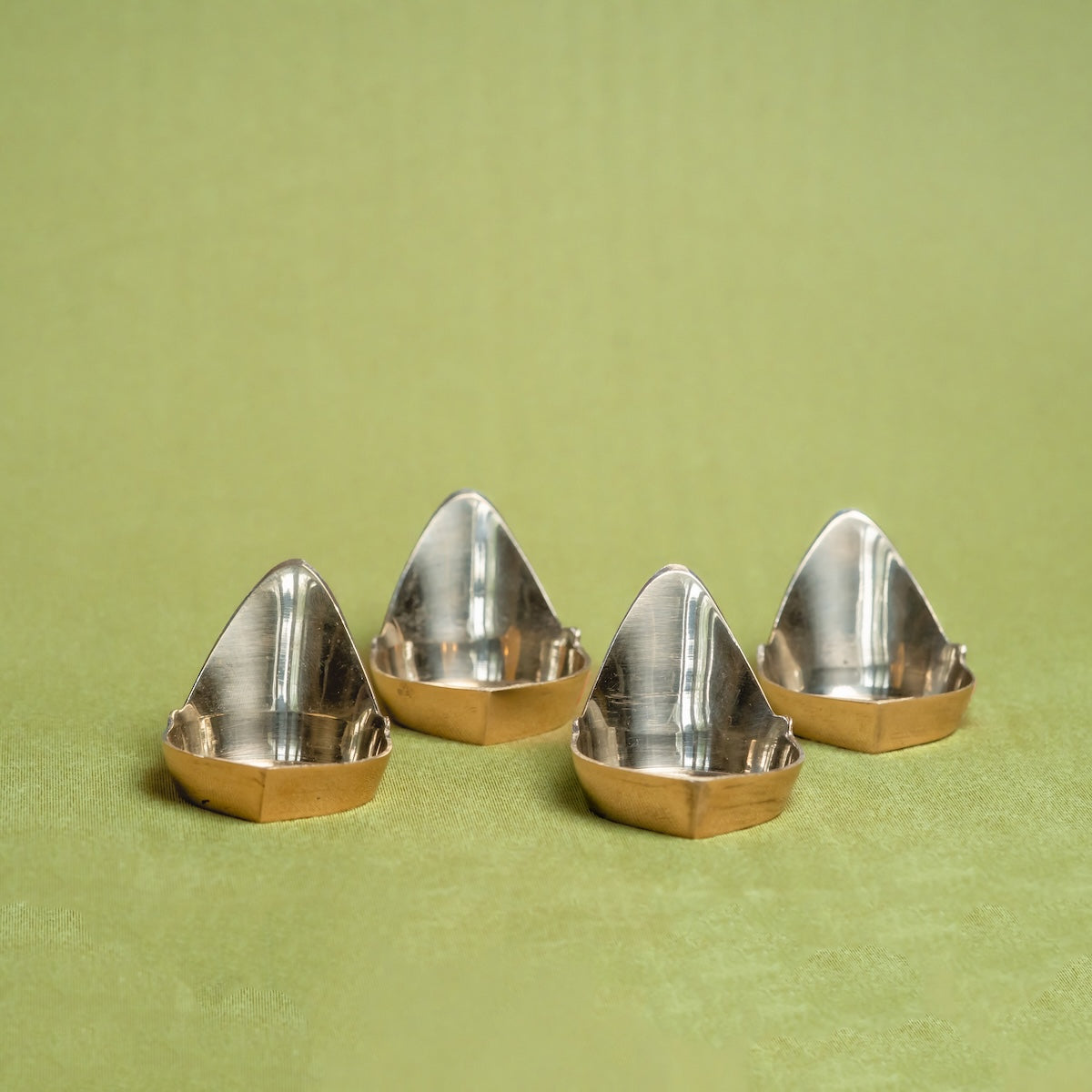 Brass Mada Vilakku Deepam on a green background-Zishta Traditional Decor-Navratri Gifting