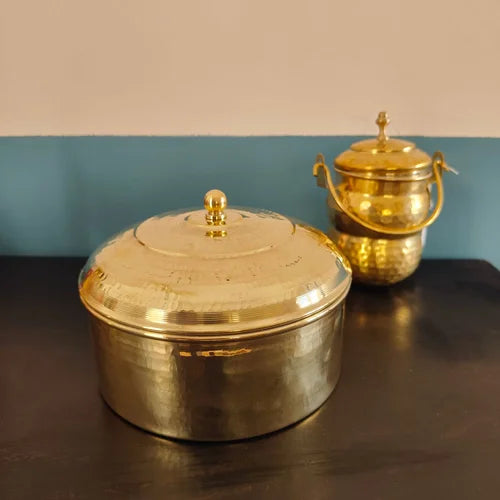 Brass Roti Box with Brass Ghee Pot in the back on a reflective surface with a blue and beige background-Zishta Traditional Kitchen Storage COntainers