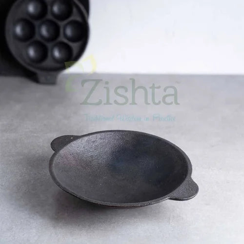 Cast iron Appam Pan-Appachatti on a gray surface-Zishta Traditional Cookware