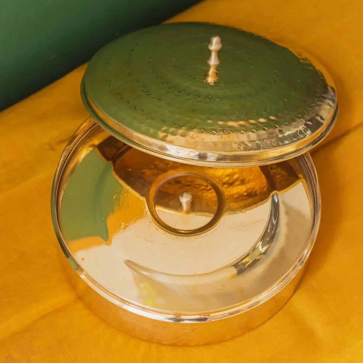Handcrafted Brass Spice Box with tin coating plate and lid on a yellow surface-Zishta Traditional Kitchen Storage Containers