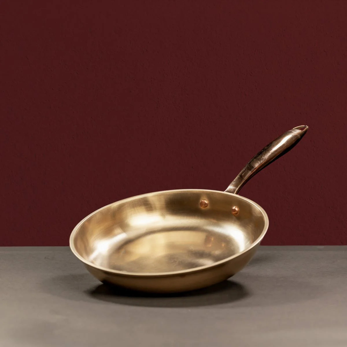 Kansa Tulsi Fry Pan in a slanting position-Zishta Traditional Bronze Cookware