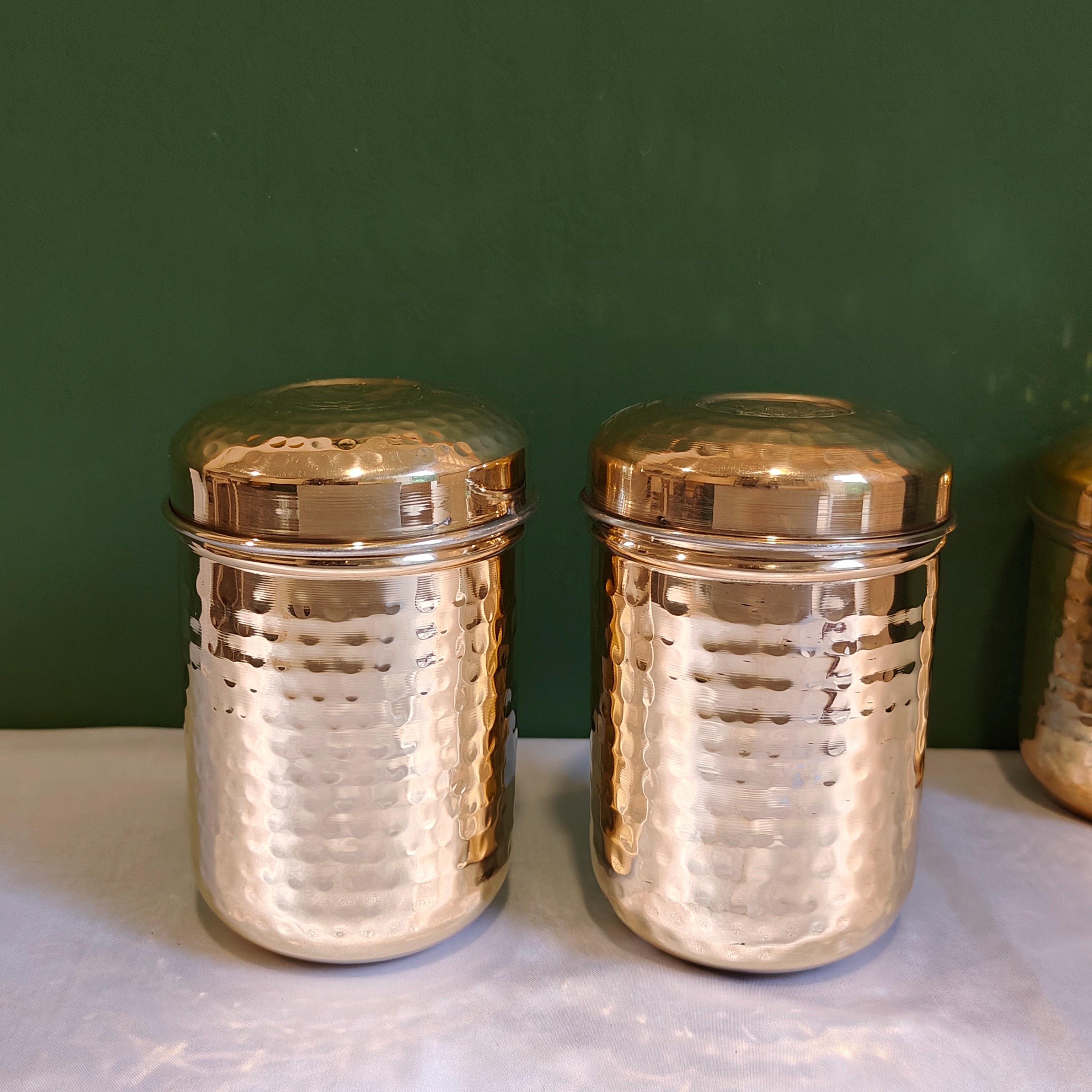https://zishta.com/cdn/shop/products/brass-storage-canister-hammered-small-set-of-2-1-zishta-storage-containers.jpg?v=1680263510&width=3072